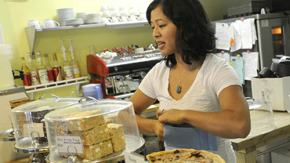 Melissa Santos of Bloomfield bags a customer order at the Dozen Bake Shop in Lawrenceville. The shop has been using Twitter to let customers know what's new.
