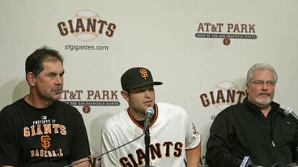 New Giants infielder Freddy Sanchez sits between manager Bruce Bochy, left, and general manager Brian Sabean, right, during a news conference at AT&T Park in San Francisco yesterday. The Giants acquired Sanchez from the Pirates.