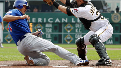 Pirates catcher Jason Jaramillo waits for the throw from center fielder Andrew McCutchen as Chicago Cubs outfielder Kosuke Fukudome scores from third on a sacrifice fly by Cubs third baseman Jeff Baker during the first inning.