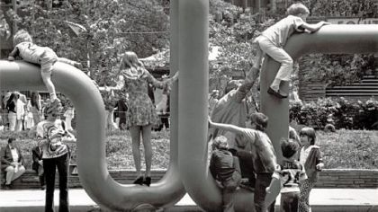 Children playing on "Pipe Dream IV," a painted tubular steel sculpture by the late Josepha Filkosky.