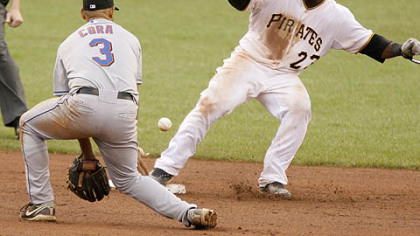 Pirates catcher Robinzon Diaz, gets back to second safely as Mets shortstop Alex Cora gets in front of the pickoff throw from catcher Omir Santos during the eighth inning yesterday.
