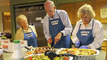 Neighbors from The Metropolitan Shadyside condominium, from left, Gisela Weis, Larry Kaplan and Marilyn Meltzer, help prepare a dinner for guests staying at the Family House Neville in Shadyside.