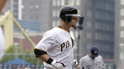 Pirates catcher Ryan Doumit heads for home past Brewers pitcher Jeff Suppan, right rear, after hitting a first-inning solo home run.