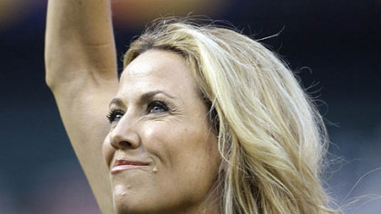 Singer Sheryl Crow waves after singing the national anthem.
