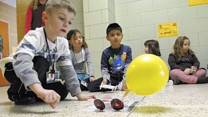 Zach Sauro, a first-grader at J.A. Allard Elementary School in Moon, releases his car powered by a yellow balloon.
