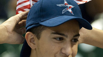 Yasna Jarah adjusts flags in his cap during last night's game between the Pirates and Astros. The flags were handed out to fans in honor of Patriot Day.