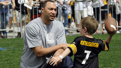 Benjamin Rankin, 6, from Moon Township, gets a lesson in quarterbacking from Steelers quarterback Charlie Batch during the Steelers 2009 Fan Blitz at Heinz Field yesterday -- part of draft day festivities.
