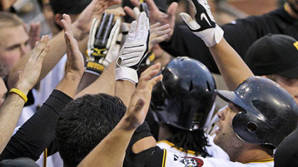 Freddy Sanchez is met by a sea of hands upon returning to the Pirates dugout after hitting a grand slam in the fourth inning to break the game open last night.