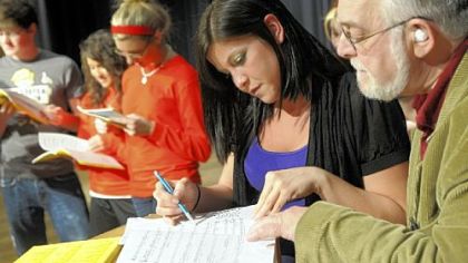 Katie Aiello looks over a score with John Carosella during a rehearsal for "Do Black Patent Leather Shoes Really Reflect Up?" The play is being performed as a fundraiser for the Tami Kunst Scholarship Fund, established by Ms. Aiello for students in the Norwin School District.