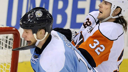 New York's Brendan Witt, right, catches Jordan Staal across the chin with his stick.