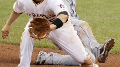 Pirates second baseman Ramon Vazquez, front, takes the late relay throw as Mets first baseman Fernando Tatis slides into second with an eighth-inning-double yesterday.