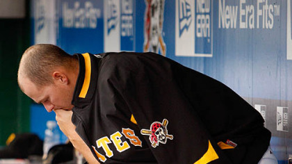 Pirates relief pitcher Steven Jackson sits in the dugout during the bottom of the ninth.