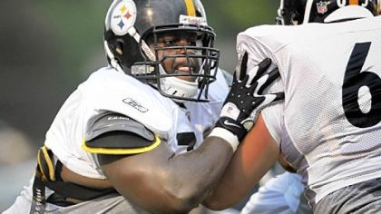 Steelers guard Trai Essex, left, blocks guard Kraig Urbik during drills at Latrobe High School Stadium last night.