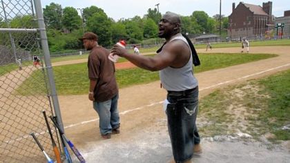 Coaches Russell Jarrett, left, and Dane Smith cheer on their Crawfords. Macedonia Baptist Church is in the background.