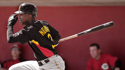 Center fielder Nyjer Morgan singles against the Reds yesterday in Sarasota, Fla.