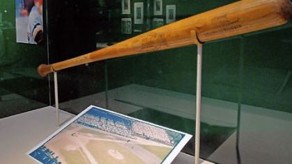 Memorabilia from Forbes Field, including a bat from Roberto Clemente, at the exhibit commemorating the 100th anniversary of Forbes Field at the Western Pennsylvania Sports Museum at the Sen. H. John Heinz History Center.