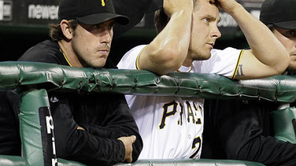 Pirates pitchers Ross Ohlendorf, left, and Kevin Hart watch the ninth inning of a 6-0 shutout by the Diamondbacks at PNC Park last night.