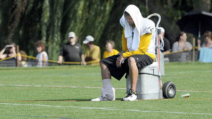 Quarterback Ben Roethlisberger sits on a water cooler near the end of practice, August 20, 2009. Roethlisberger injured his right foot when tackle Max Starks fell on him during pass drills near the end of practice.