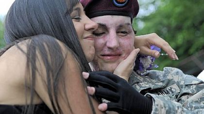 Brianna "Breezy" Kammerdiener hugs her brother, Kevin, before he was awarded the Purple Heart yesterday.