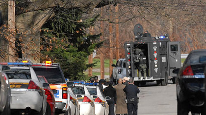 Police officers stand by at the scene on Fairfield Street where three Pittsburgh police officers were killed this morning and two were wounded, after they responded to a domestic call.