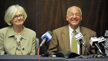 Dr. Cyril H. Wecht, seated by his wife Sigrid Wecht, speaks at a news conference about the dismissal of all charges against him.