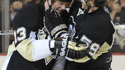 Kris Letang, right, congratulates Bill Guerin's game winner.