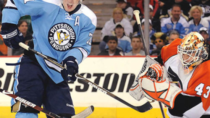 Flyers goalie Martin Biron makes a save against Evgeni Malkin in the third period yesterday at Mellon Arena.