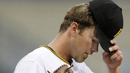 Pirates pitcher Zach Duke adjusts his hat after serving up a third-inning home run to Cubs outfielder Ryan Theriot last night.