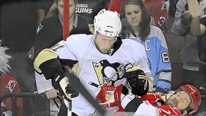 Penguins Jordan Staal collides with the Carolina Hurricanes Scott Walker at the RBC Center.