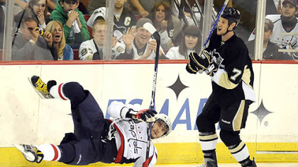 The Capitals' Alex Ovechkin hits the ice after getting checked by Penguins' Mark Eaton in the third period of Game 4 of the second round of the Stanley Cup Playoffs at Mellon Arena last night.