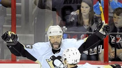 Bill Guerin celebrates his second-period goal with Chris Kunitz against the Hurricanes last night.