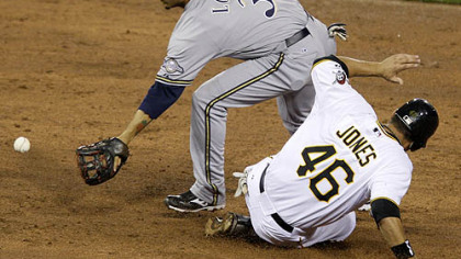 Pirates outfielder Garrett Jones gets to second ahead of the toss from Brewers shortstop J.J. Hardy to second baseman Felipe Lopez in the second inning.