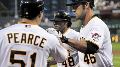 Garrett Jones (46) celebrates with teammates Steve Pearce and Delwyn Young after hitting a home run in the third inning last night against the Brewers at PNC Park.