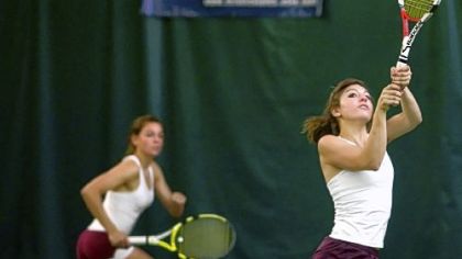Chartiers-Houston sisters Karli Timko, left, and Tanya compete against Harrisburg Academy's Andrew Kantor and Ted Otto in a PIAA first-round boys' doubles match yesterday at the Hershey Racquet Club.
