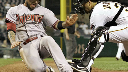 Pirates catcher Jason Jaramillo loses the ball as he attempts to tag Diamondbacks infielder Ryan Roberts during the eighth inning.