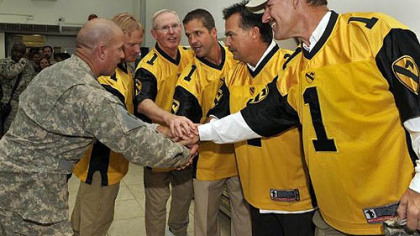 U.S. Army CSM Larry Wilson (L) joins hands with NFL coaching legends (L-R) Jon Gruden (formerly Tampa Bay Buccaneers and Oakland Raiders), Tom Coughlin (NY Giants), John Harbaugh (Baltimore Ravens), Jeff Fisher (Tennessee Titans) and former Steelers Coach Bill Cowher  prior to a USO appearance at Forward Operating Base Warrior near Kirkuk, Iraq, Thursday.