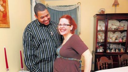 Tyrone and Leslie Gore in their home in Penn Hills are expecting a baby this July.