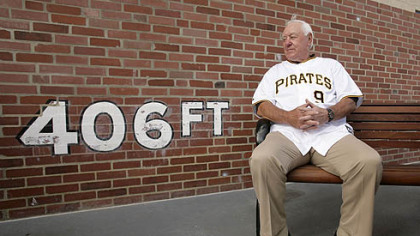 Pirates Hall of Famer Bill Mazeroski sits in front of a replica of the left field wall at Forbes Field, at PNC Park before last night's game against the Cubs. Yesterday marked the 100th anniversary of the first game to be played in Forbes Field.