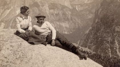 Lounging on Eagle Rock in Yosemite National Park, circa 1902, with Half Dome and Nevada Falls in the background.
