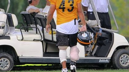 Safety Troy Polamalu walks off the practice field with ice bags wrapped around both legs at the end of practice yesterday at Saint Vincent College in Latrobe.