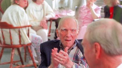 Gene Puhl applauds the piano playing of Vince Lascheid during a session at Marian Manor, where Mr. Lascheid played music for the residents as part of a Mother's Day event in 1999.