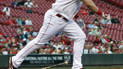 Reds outfielder Jonny Gomes watches his ground-rule double hit off Pirates pitcher Paul Maholm, scoring second baseman Brandon Phillips in the first inning of the second game.