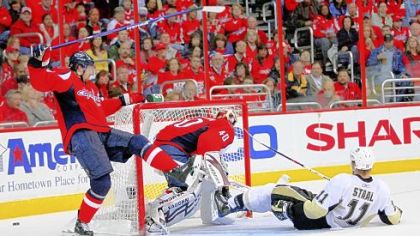 Jordan Staal winds up on the ice Monday night after challenging Shaone Morrisonn, left, and Simeon Varlamov.