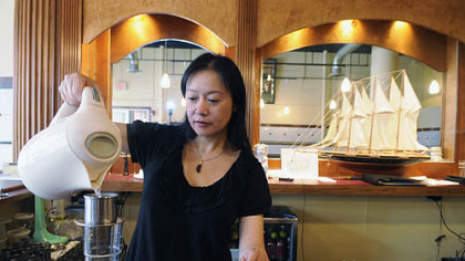 Jade Shang makes Vietnamese iced coffee at Vietnam's Pho in the Strip District.