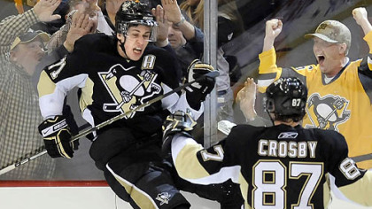 Evgeni Malkin celebrates his third-period game-tying goal with teammate Sidney Crosby.