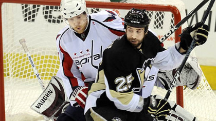 Max Talbot battles for a loose puck against the Capitals' Tyler Sloan Wednesday at Mellon Arena.