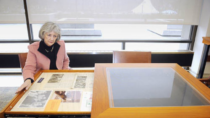 Nancy Watson, curator of the Thornburgh Collection at Hillman Library, opens a drawer in a display table with material from the Three Mile Island accident in the Dick Thornburgh room at the University of Pittsburgh library.