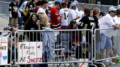 Fans after sunrise claim their favorite viewing spots for today's parade.