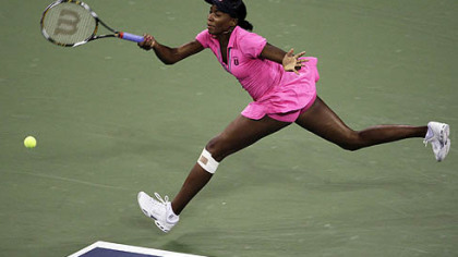 With her knee bandaged, Venus Williams stretches to hit a return during her match against Vera Dushevina at the U.S. Open in New York yesterday.