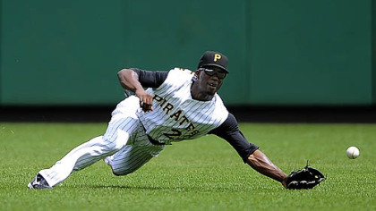Pirates outfielder Andrew McCutchen pulls in a ball hit by Cubs outfielder Jake Fox in the fourth inning last night.